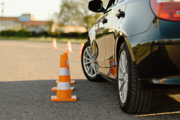 car and traffic cones, driving school concept