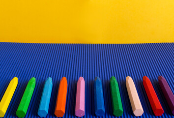 Frame of crayons on the blue background.Empty space.Creative time for kids