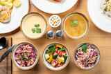 Fototapeta Kuchnia - Menu photo of different kinds of salads and soups, directly above studio shot, full table
