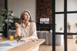 © Drobot Dean - Woman sitting at kitchen indoors at home while eating salad.