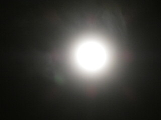 the moon shines in the night sky.