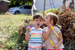 © Jelena Stanojkovic - Three years old brother and sister blowing bubbles in the backyard.Cute blond girl kissing her little brother in the cheek.Children in the park blowing soap bubbles and having fun in the summer time.