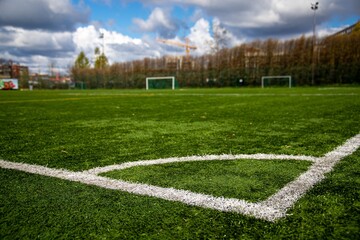 Poster - Soft focus of the corner arc of a football field with lush grass