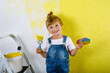 © Irina Schmidt - Cute little toddler girl painting the wall with yellow color in new house. Family repair apartment home. Happy child girl paints the wall, choosing color with palette, having fun with brush, indoors