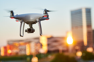 Wall Mural - drone with digital camera flying at city street