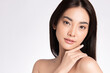 © kitthanes - close up Beauty face. Smiling asian woman touching healthy skin portrait. Beautiful happy girl model with fresh glowing hydrated facial skin and natural makeup on white background,