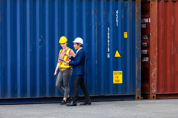 Wall Mural - Man manager and woman Supervisor dock cargo checking and control loading Containers box at container yard port of import and export goods. Unity and teamwork concept