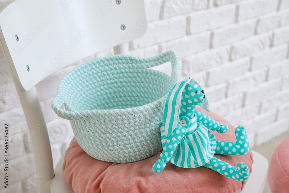 Chair with basket and kid toy in room