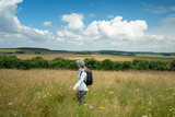 Fototapeta  - Young Tourist, Walking In Meadow In Russia In Summer.