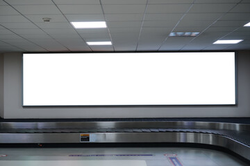 LCD Blank billboard at conveyor belt luggage in airport. Wide screen for cutomer text information advertise about tourism transport business etc. advertising mock up empty in metropolitan