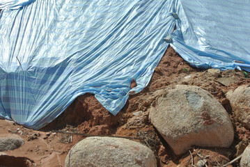 Wall Mural - SEREMBAN, MALASIA - MARCH 3, 2019: The plastic sheet is spread over the surface of the slope to prevent erosion. Also to temporarily stabilize the slope before the permanent stabilization work done.