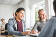 © Maskot - Smiling young man with female friend in classroom