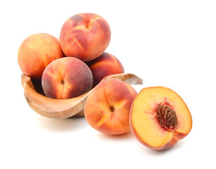 sweet peaches in wooden bowl on a white background 