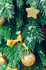 Green fir tree with golden balls. Christmas wallpaper.