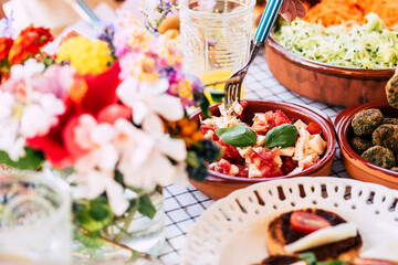 Close up of table full of fresh seasonal healthy food for group of people - lunch or brunch background coloured composition