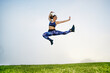 © Tetra Images - Mixed race woman exercising and jumping in field