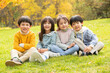 © View Stock - Lovely children sitting on the grass to play