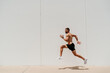 © VISTA by Westend61 - Barechested male athlete jumping at a wall