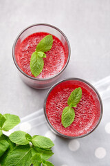 Strawberry mousse with mint leaves in two glasses, delicious summer berries dessert