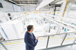 © Westend61 - Businessman standing on upper floor in a factory