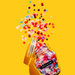 © Westend61 - Colorful confetti spilling from glass jar