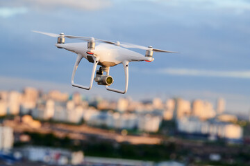 Wall Mural - drone with digital camera flying at city street
