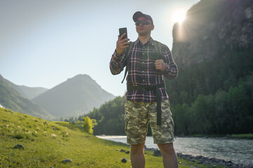 Wall Mural - man with phone in the mountains