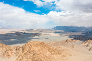 aerial view of sand moutain in desert with blue sky