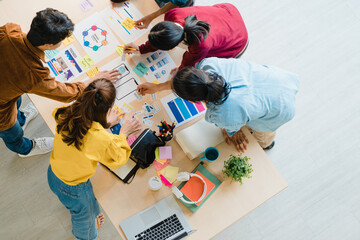 Wall Mural - Multiracial group of young creative people in smart casual wear discussing business brainstorming meeting ideas mobile application software design project in modern office. Coworker teamwork concept.