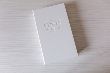 White box for printing photo. Box with lettering on white wooden table