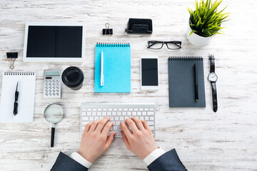 Businessman hands working at vintage wooden desk