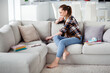 © deagreez - Profile photo of pretty lady student browsing notebook sit cozy sofa video call listen teacher lesson online conference education concept good mood social distance quarantine indoors