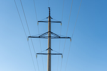 Power lines aerial and power supply against the blue sky