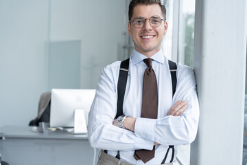 Canvas Print - Portrait Of Businessman Standing By Window In Office