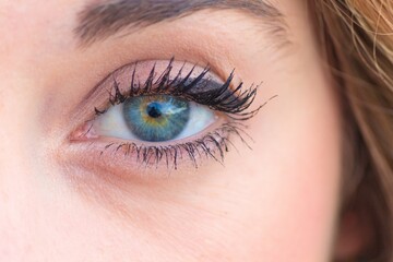 Poster - Closeup shot of a young female with blue eyes