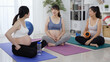 © PRPicturesProduction - group of asian females with swollen bellies are chatting after yoga class. korean mothers-to-be are resting and talking on exercise mat.