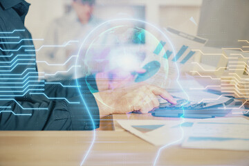 Wall Mural - man with computer background with brain theme hologram. concept of brainstorm. double exposure.