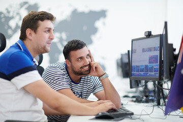 two male software developers working on computer