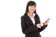 © Nipapun - Young Asian business woman in black suit with long hair using smart phone connecting internet  on white background and looking at the camera,happy  ,studio isolated.