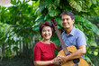 © toa555 - Middle aged  couple playing guitar while relax sitting on bench in backyard.