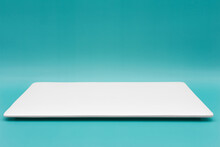 A Rectangle Empty White Plate Isolated On The Tiffany Blue Background.
