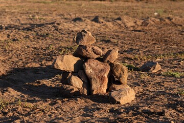 Poster - Closeup shot of a pile of small stones on the sand