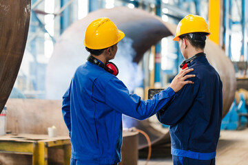 Expert checking the quality of manufactured boilers