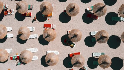 Wall Mural - Aerial Drone View Of Ocean Beach, People Having Fun Under Umbrellas On Summer