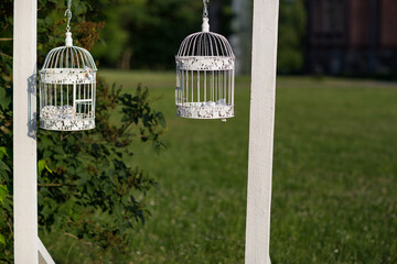 two decorative cages hang on the window