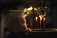 Little Boy Is Looking At Candels And Angel Chimes, Christmas Decoration Angel Chimes