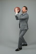 © be free - Businessman warm up with basketball in office, prepare to throw concept