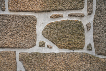 Old real stone wall surface texture. Pattern white, yellow modern style design decorative uneven cracked rocks. 