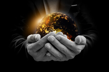 Canvas Print - environment concept. earth with light in hands on black background. elements of this image furnished