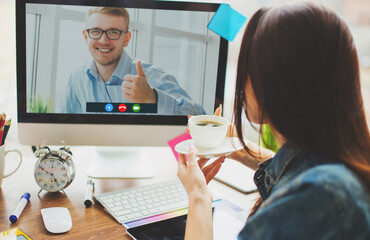 Wall Mural - Web designer talking online with director from home